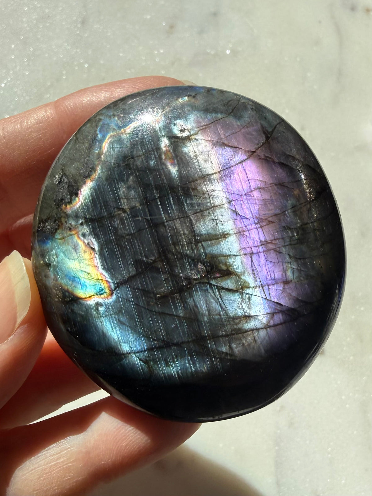 Polished Labradorite palm stone with vivid blue, violet and silvery flash, a one-of-a-kind Madagascar crystal