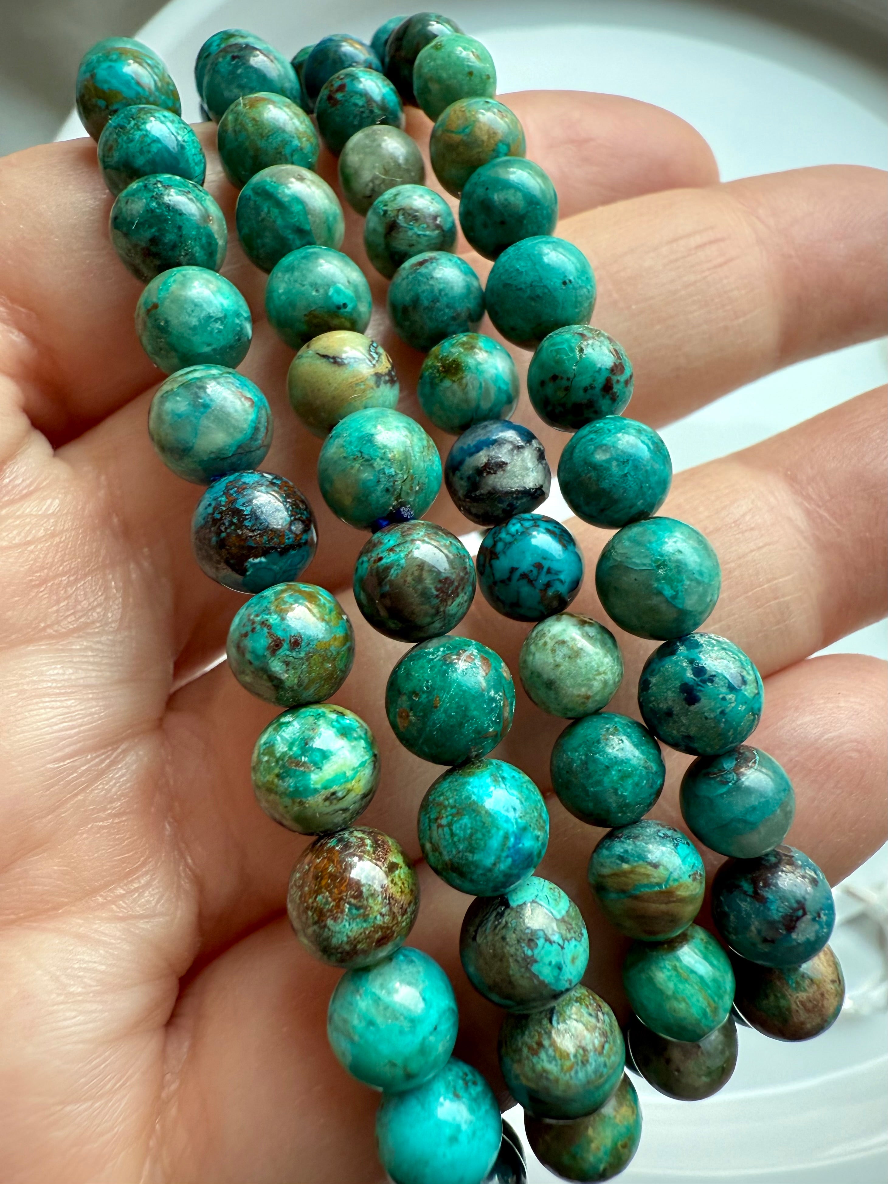 Close-up of Chrysocolla Shattuckite beads revealing intricate natural patterns, handmade crystal bracelet for clarity and insight