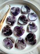 dream amethyst heart worry stones displayed on dish for meditation calm and spiritual awareness