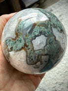 Large Moss Agate display sphere with natural crystal formations for meditation and sacred spaces