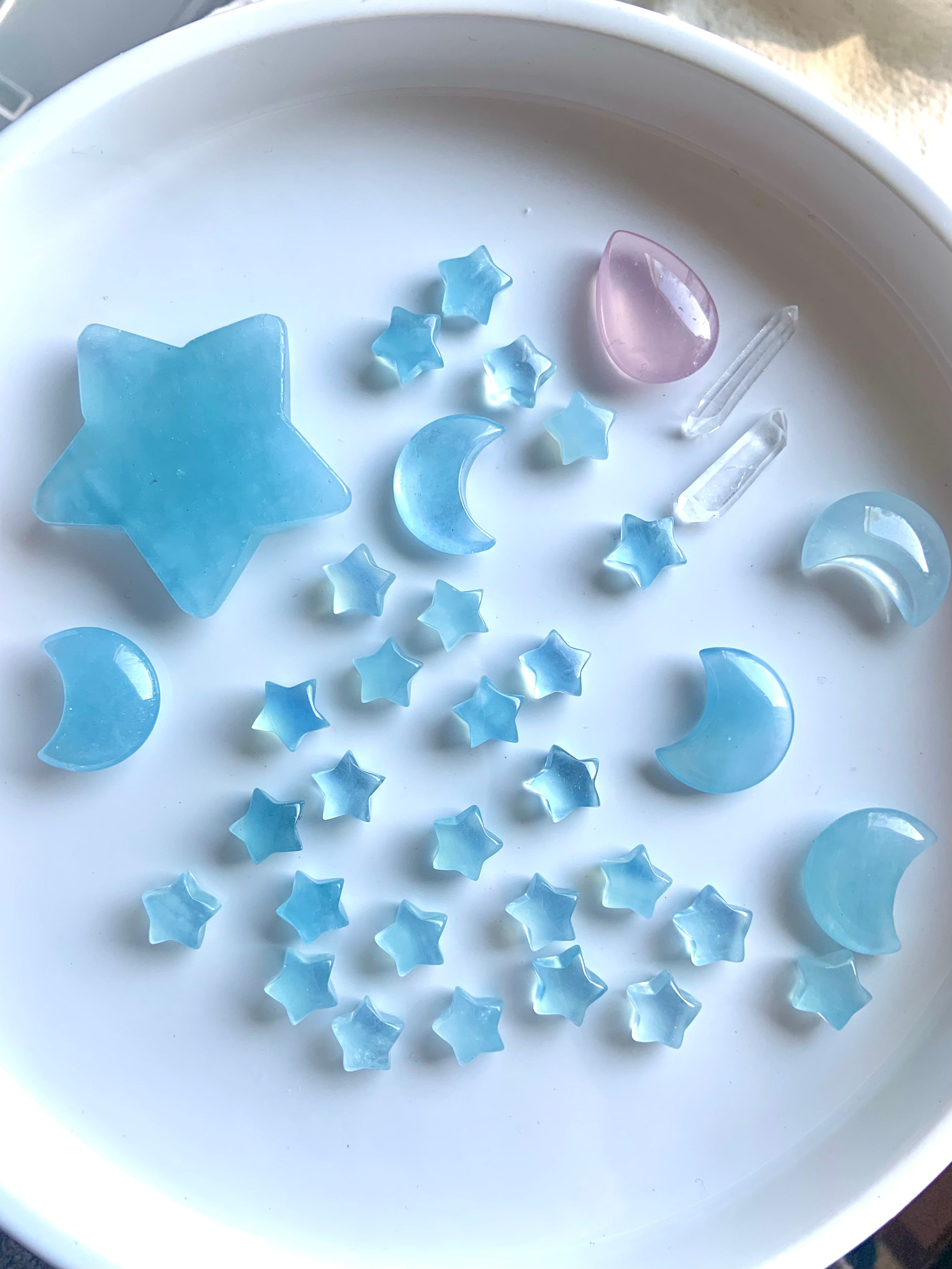 Assorted Aquamarine crystal stars and moons on white background