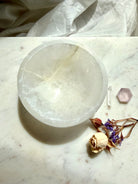 round selenite crystal bowl styled with dried flowers and quartz, luminous charging dish for crystals and jewelry