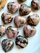 Polished Rhodonite heart carvings with pink stone and contrasting black manganese veining