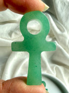 Close up of green aventurine ankh carving showing natural translucency and subtle stone patterning