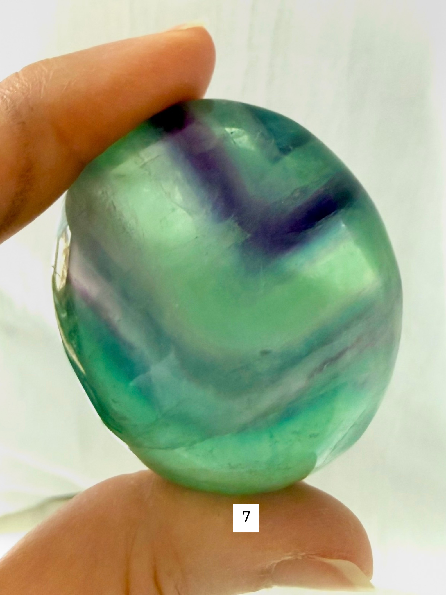 Rainbow Fluorite Palm Stone #7 with teal and purple ribbon banding and luminous color layers