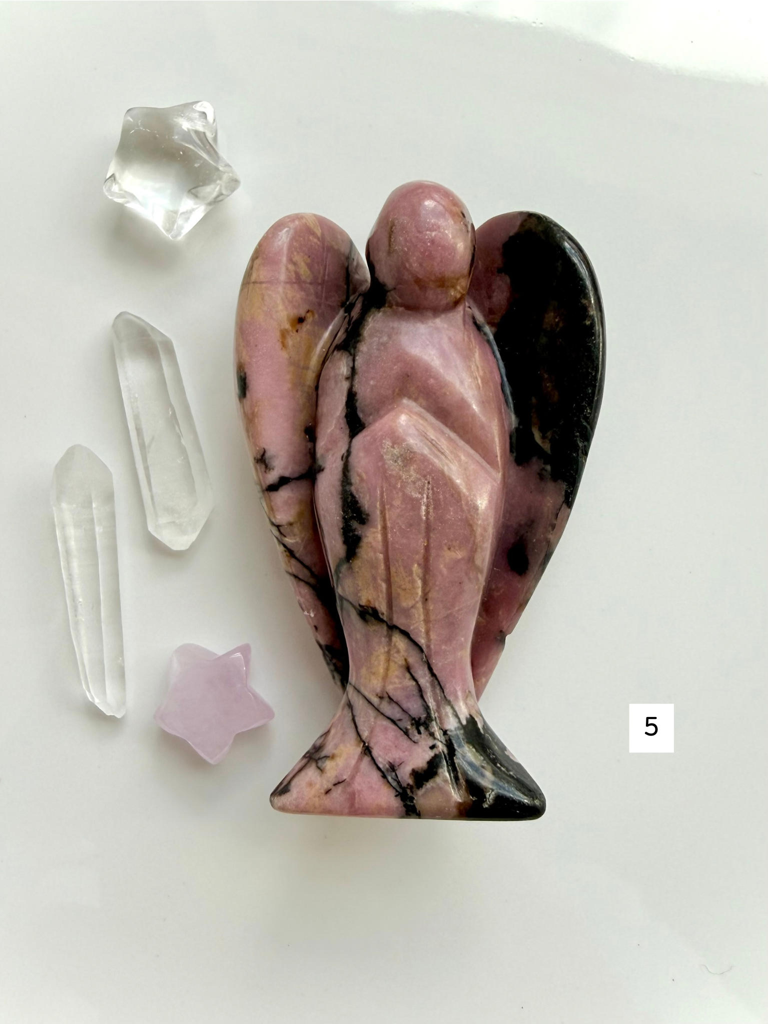 Polished Rhodonite angel crystal with rich rose tones for comfort and self-love