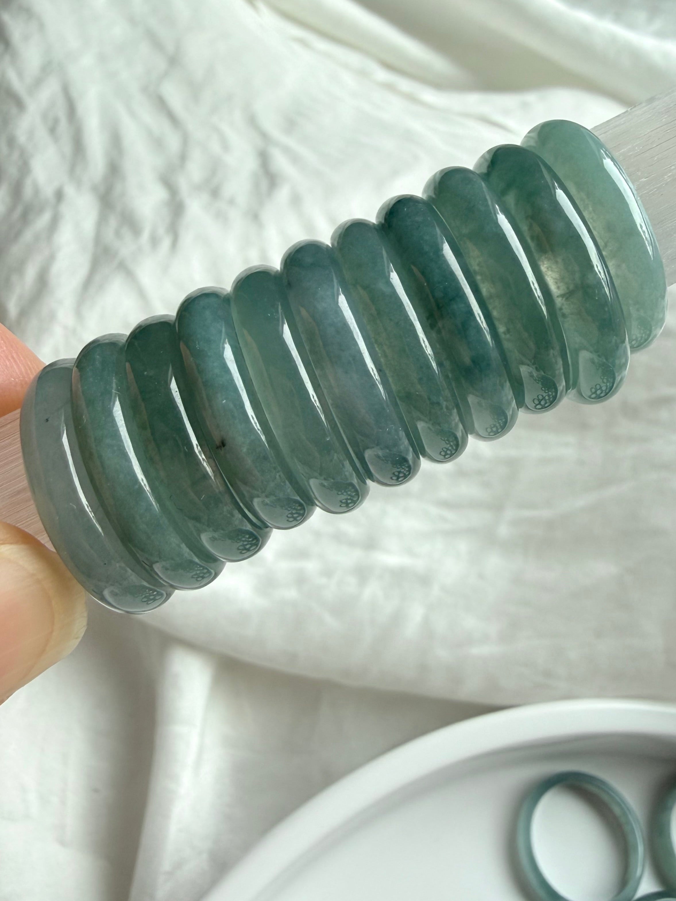 Stacked rounded jadeite band rings showing thickness and polish of Blue Water jade
