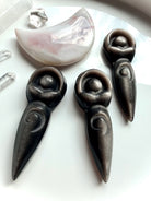 Silver Sheen Obsidian spiral goddess carvings with luminous silver shimmer and detailed Spiral of Life design