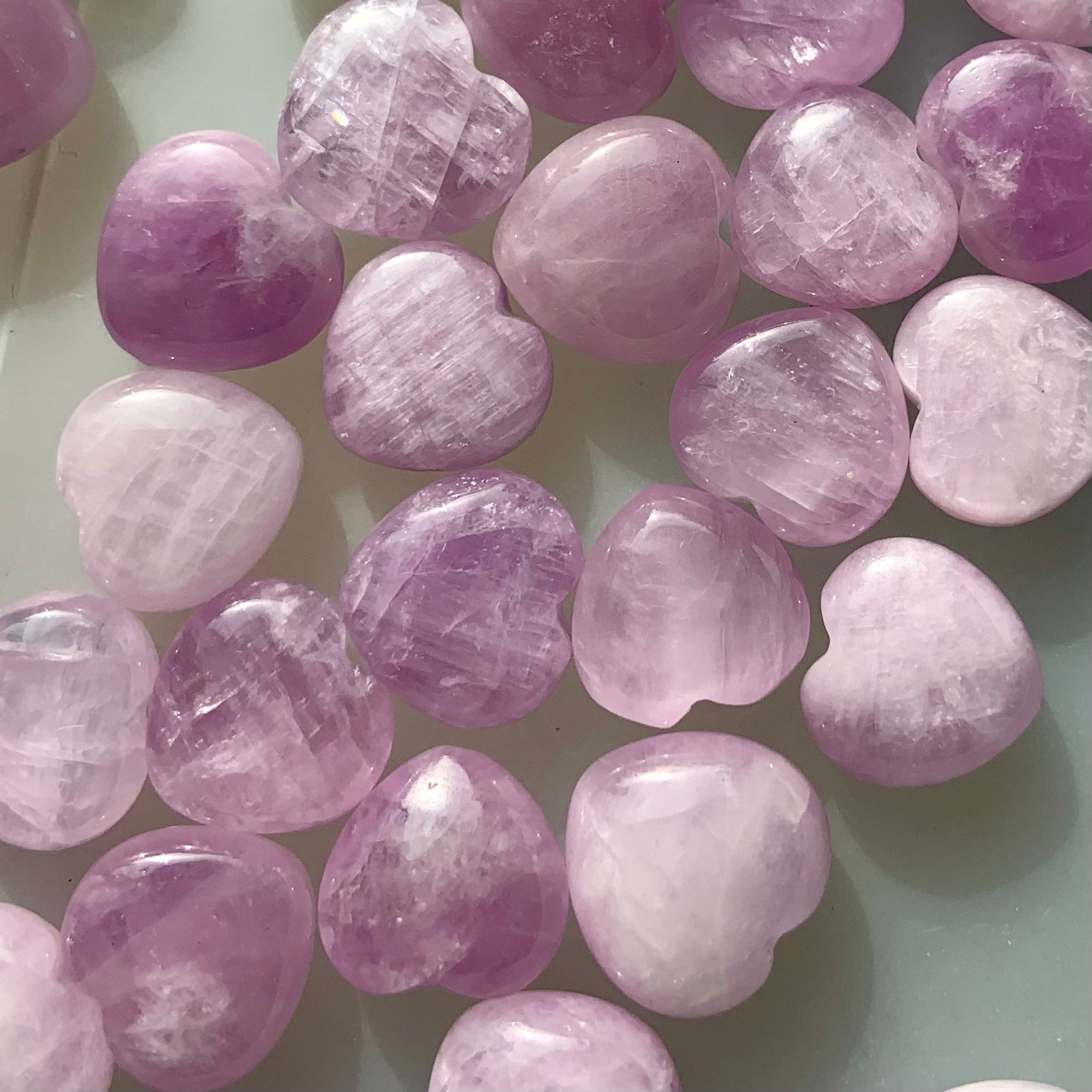 Close-up detail showing shimmer & color variations in Pink Kunzite mini hearts — radiant crystals for love & heart-centered energy.