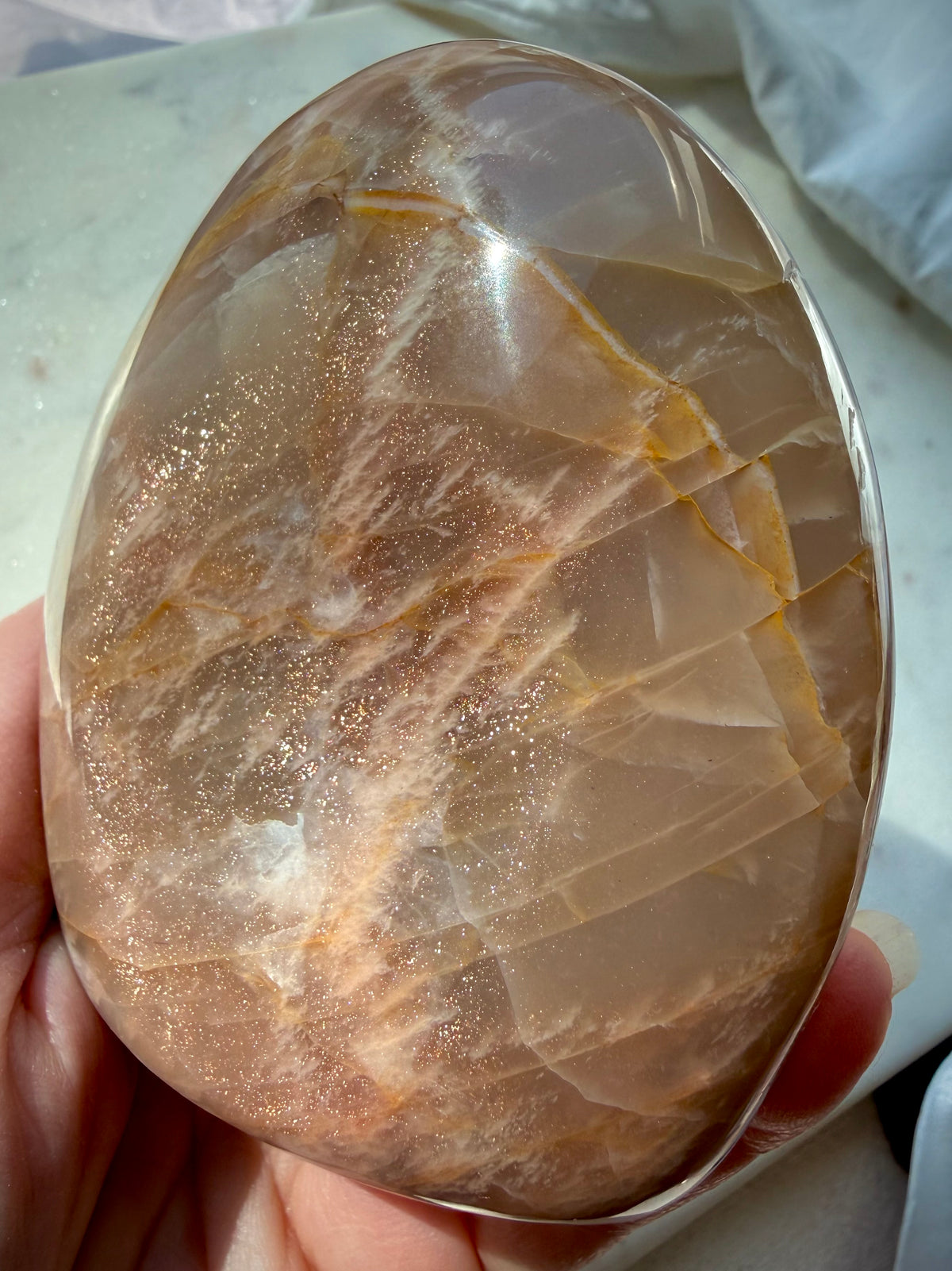 Peach Moonstone crystal showing warm peach color, natural inclusions and golden Sunstone shimmer