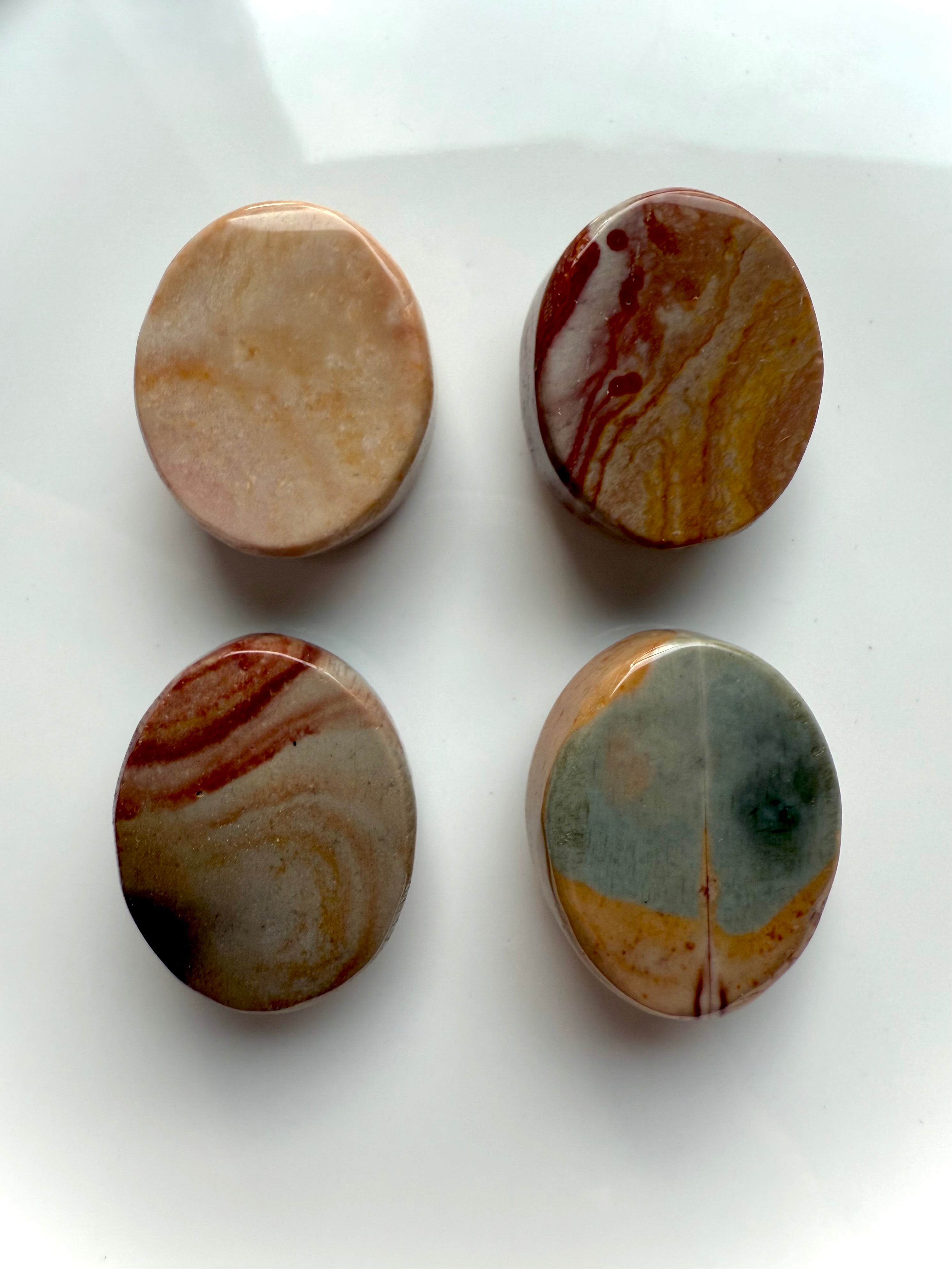 Back view of Polychrome Jasper cabochons showing natural patterns and color variations — polished crystal ovals for grounding and earthy energy work.
