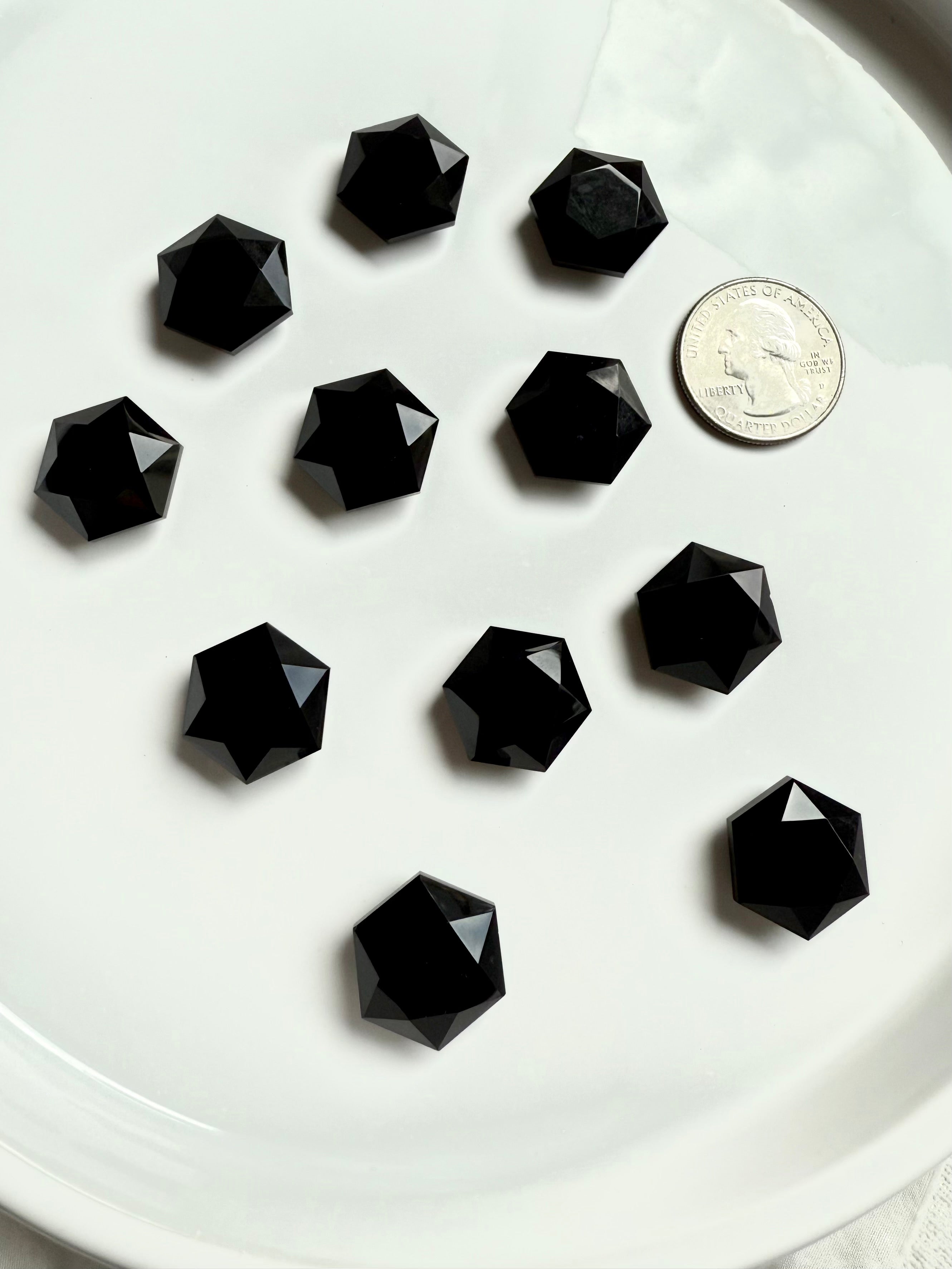Small faceted Obsidian crystal with quarter for scale