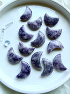 Celestial Lepidolite crystal carvings featuring polished crescent moons and stars in naturally varied shades of purple