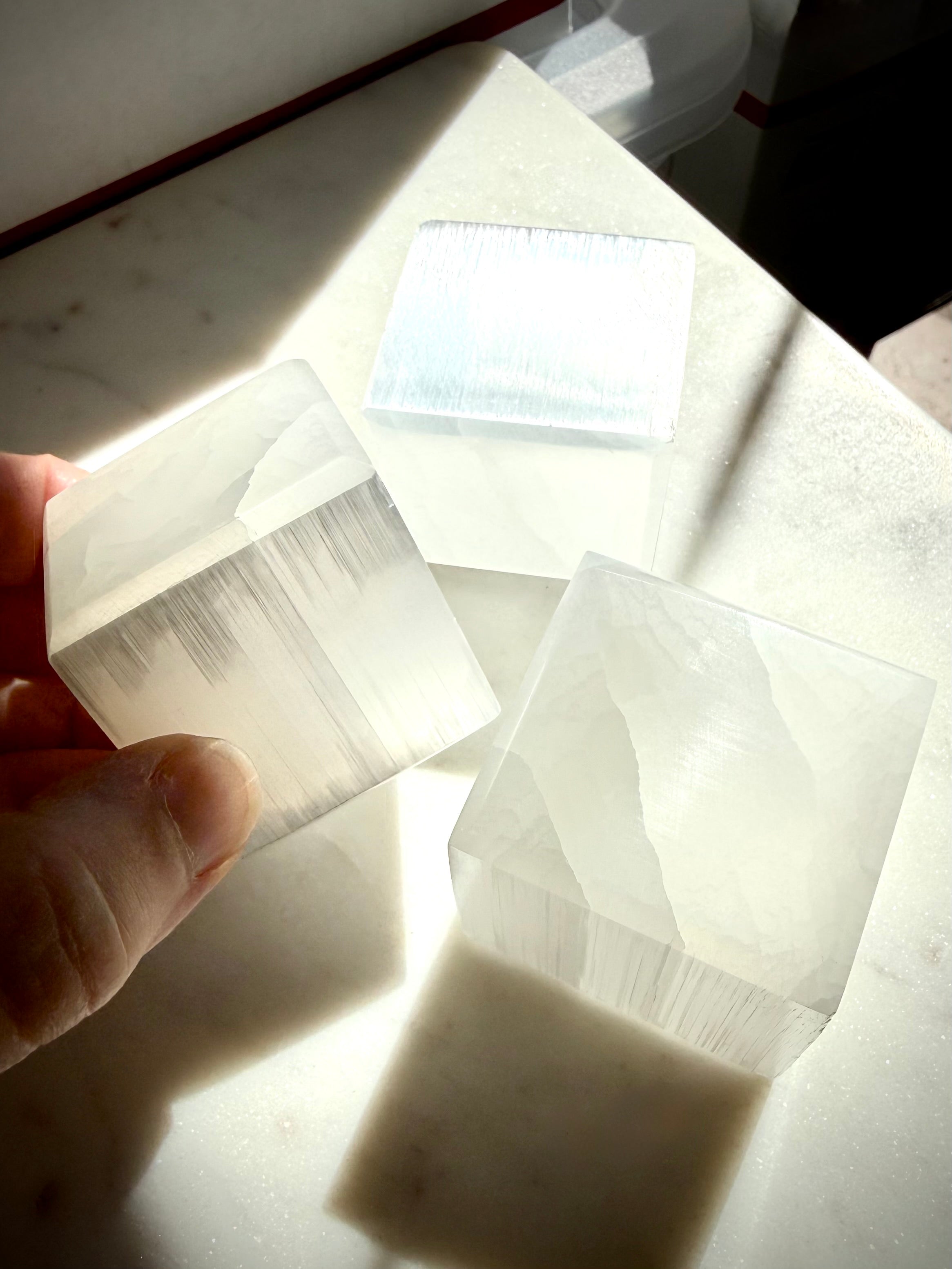 White Selenite cubes with translucent faces and luminous fibrous crystal structure