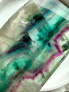 Close-up of natural fluorite slab showing layered color zoning and polished crystal surface