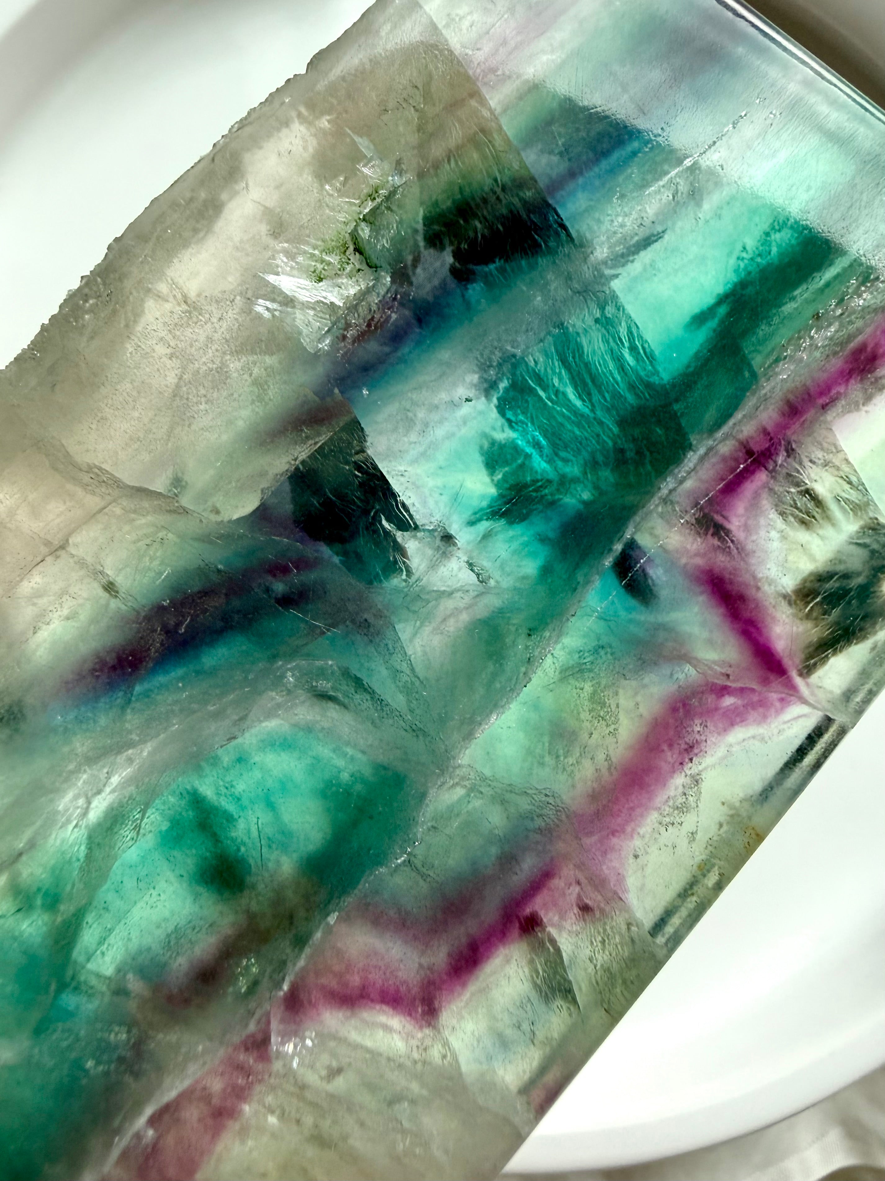 Close-up of natural fluorite slab showing layered color zoning and polished crystal surface
