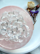 Mini Clear Quartz crystal hearts displayed in a rose quartz bowl with luminous transparent quartz