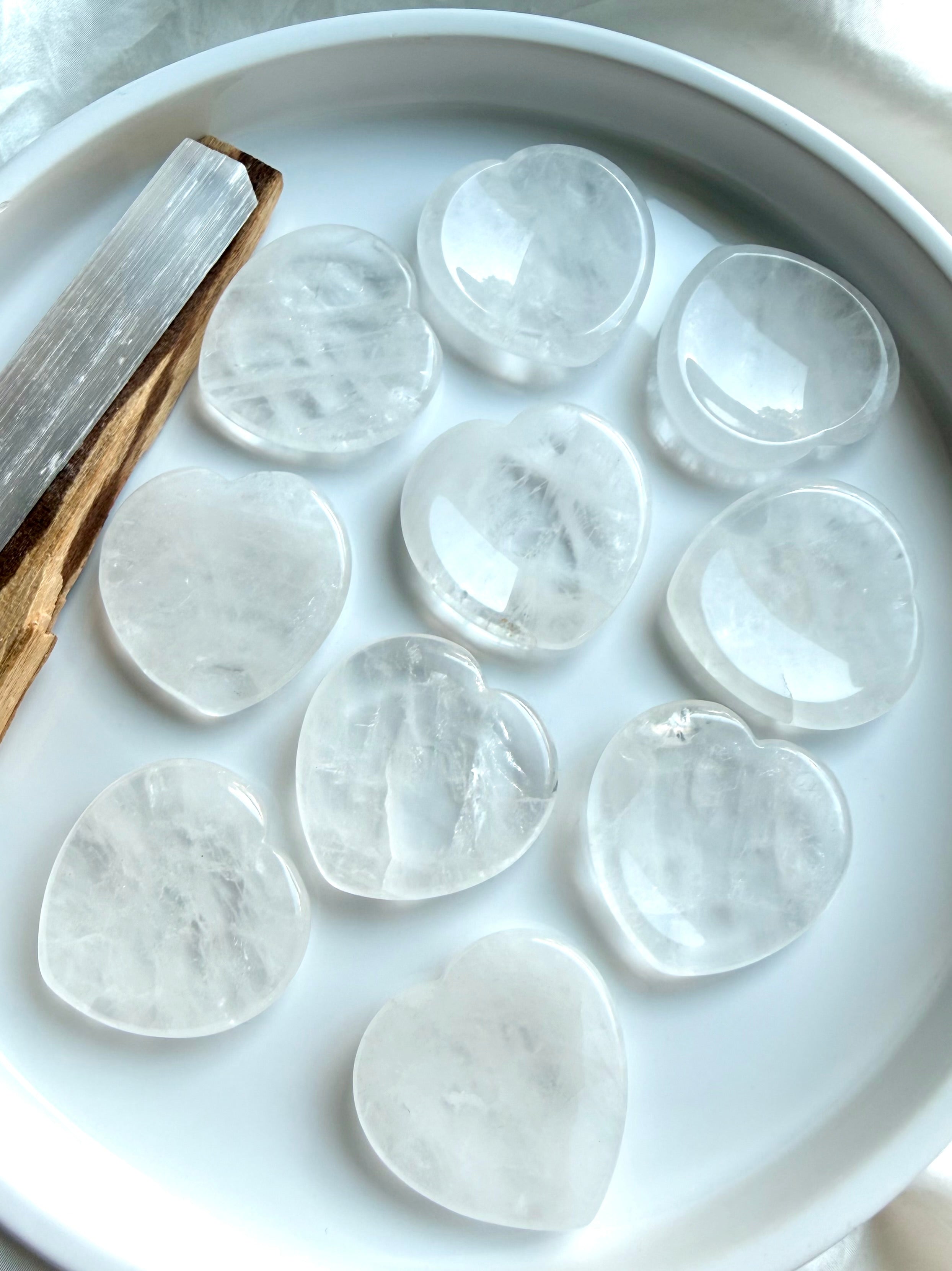clear quartz heart stones displayed on dish for chakra healing clarity and energy work