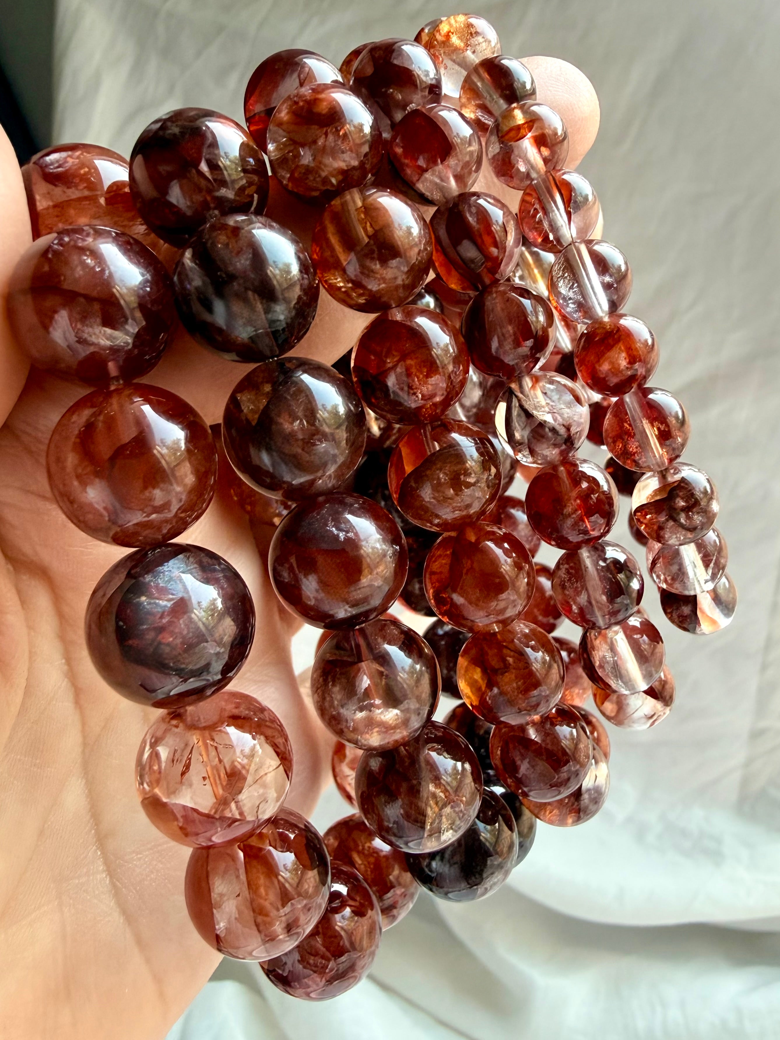 Fire Quartz bracelets with luminous Red Hematoid Quartz beads in deep red, smoky and translucent tones for grounding and vitality