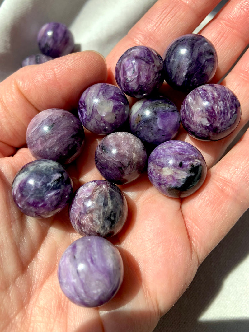 Purple Charoite mini spheres shown on my hand for scale 