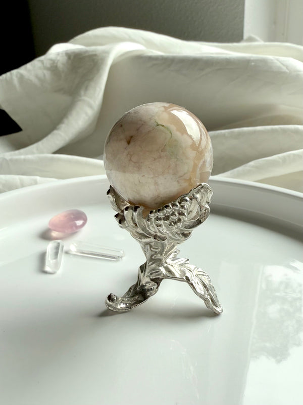 Our elegant botanical mini sphere stand fits small crystal spheres, shown with a flower agate sphere