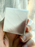 Close-up of Selenite cube with silky white striations and translucent satin spar crystal structure