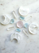 Crystal grid featuring clear quartz moons, quartz points, rose quartz, and aquamarine moon carvings — a layout for peace, clarity, and divine connection.