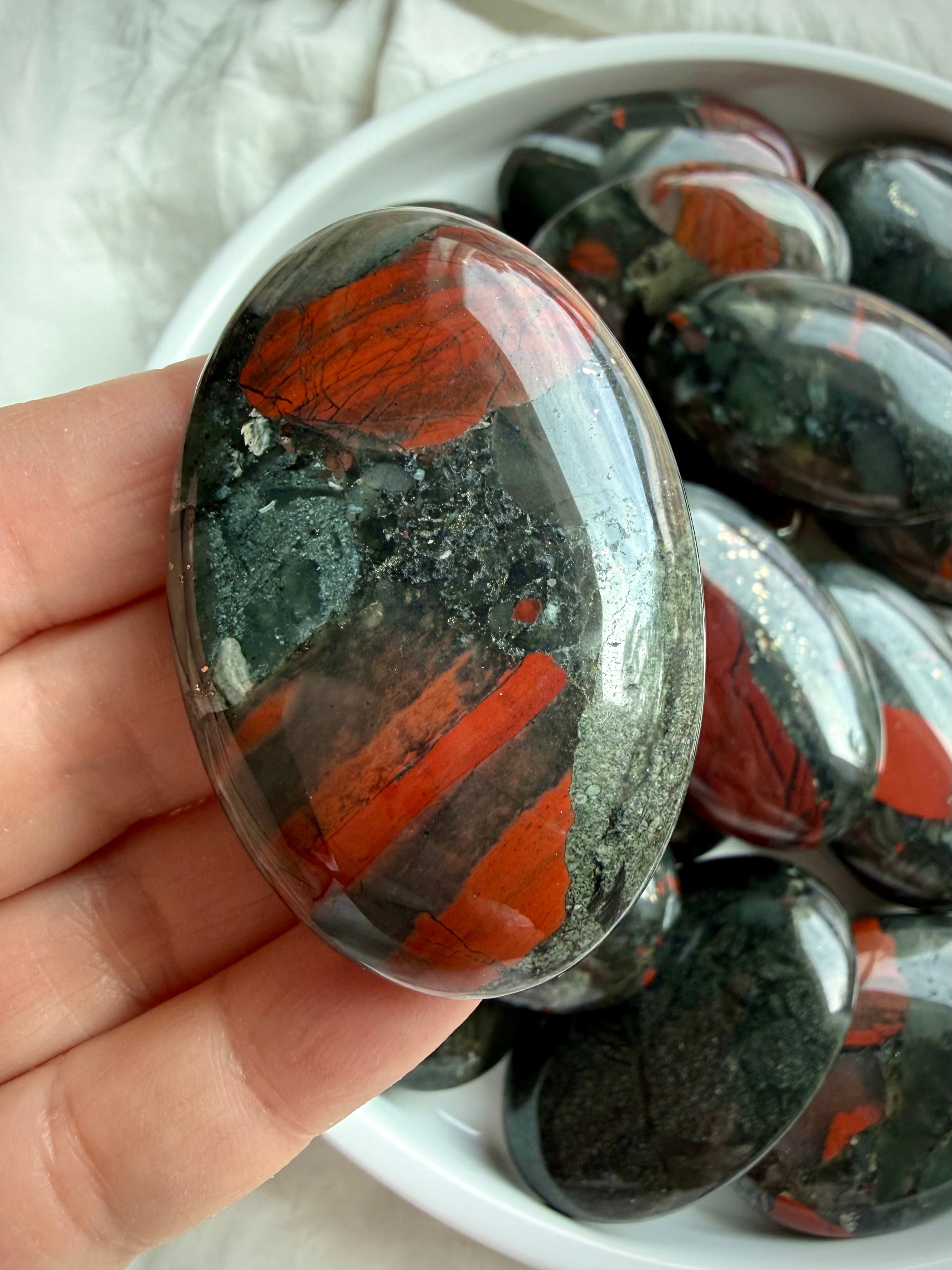 Polished Bloodstone palm stone with vivid red Jasper-like inclusions, dark green matrix and natural pyrite specks