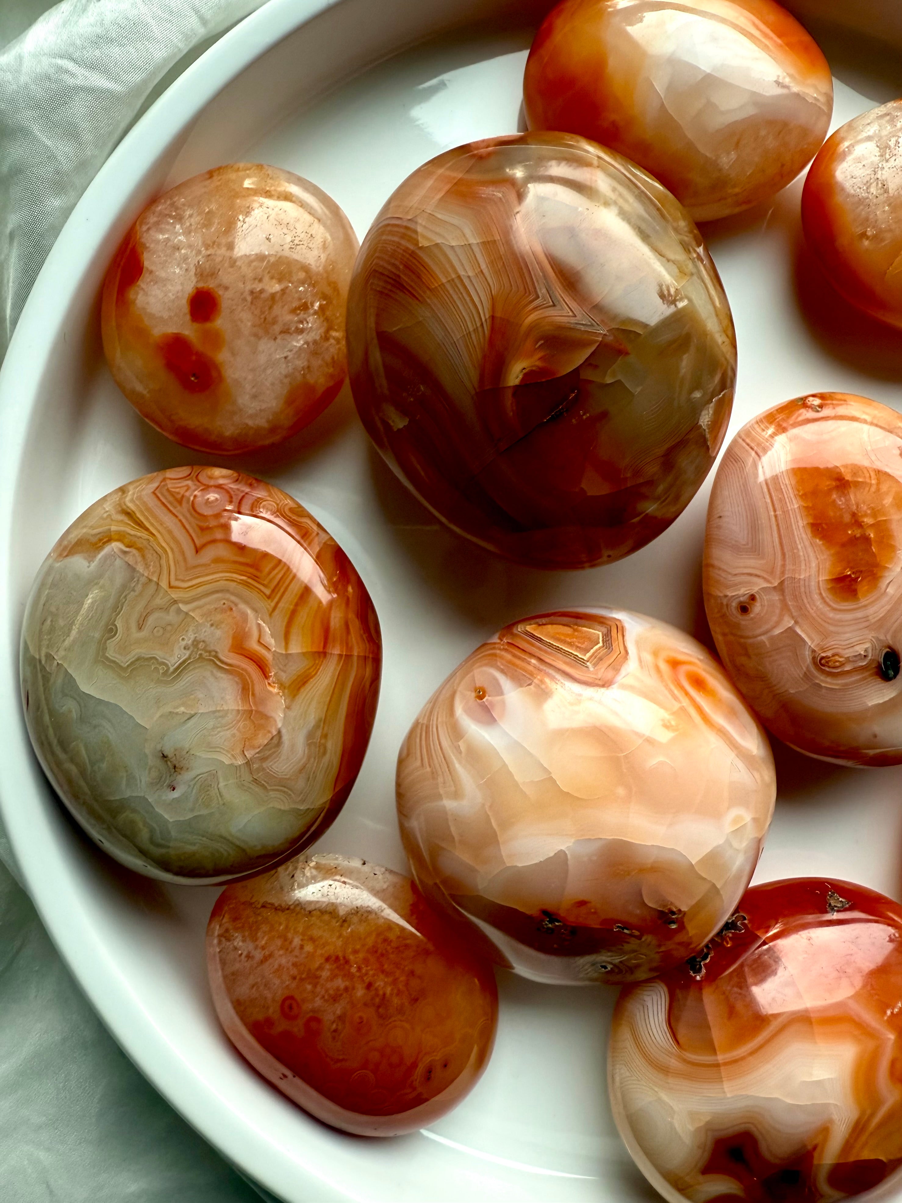 Carnelian palm stones with fiery banding + druzy details — energizing sacral chakra crystals for joy + creativity