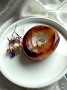 Carnelian gemstone bowl used as a jewelry dish – hand-carved crystal for altar rituals and sacred offerings