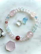 single mixed gemstone bracelet styled flat with rose quartz aquamarine and strawberry quartz beads, crystal bracelet for emotional healing and calm