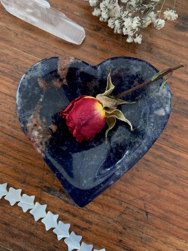 Hand carved blue Sodalite Heart Bowl or stone ring dish. Picture shows a red rose inside.