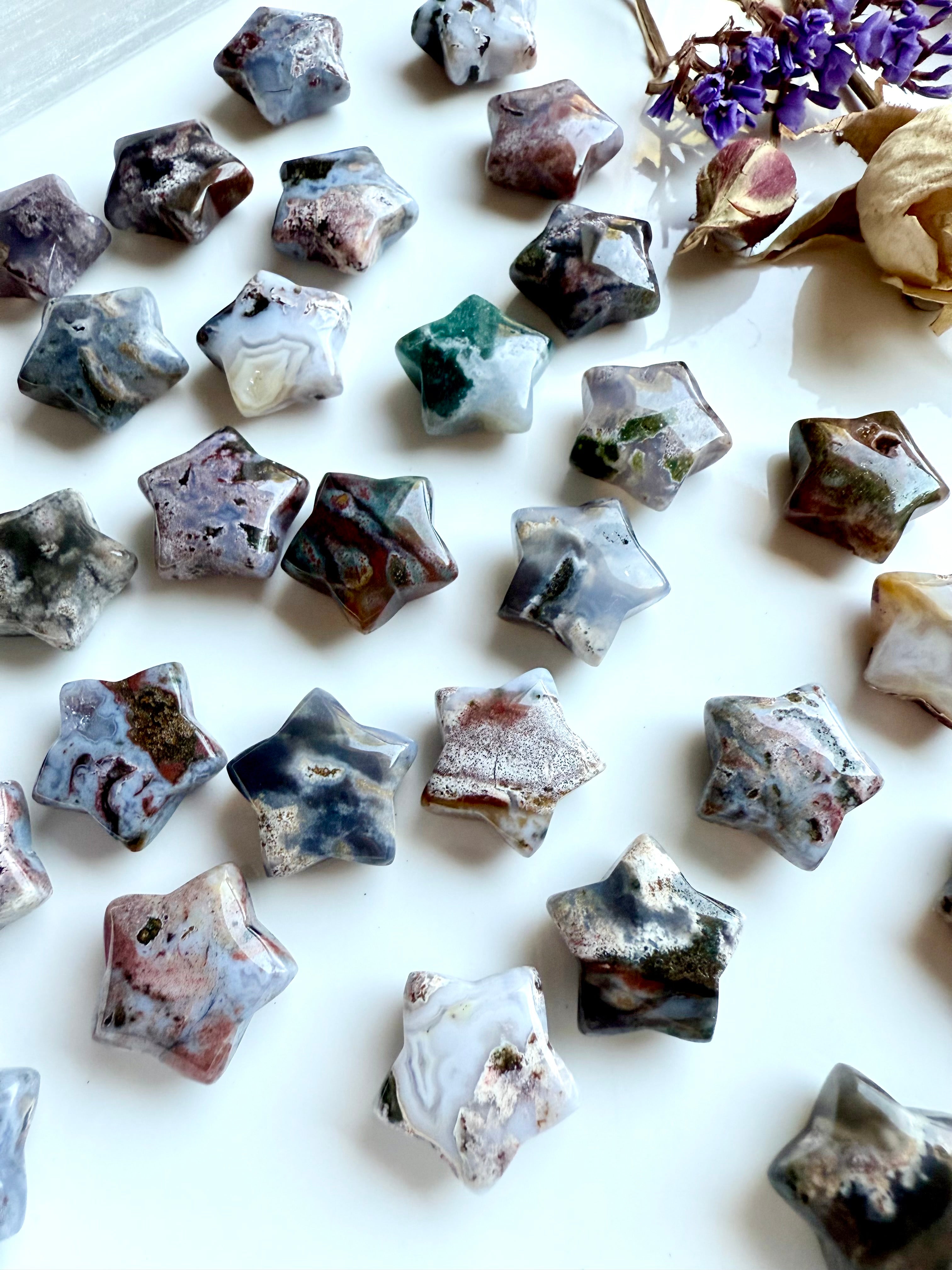 Group of mini Ocean Jasper star carvings with multicolored patterns and textures