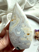 Quartz-rich Moss Agate flame with natural orbicular formations and soft glow