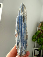 Raw blue kyanite and muscovite specimen showing natural mineral formation and silvery reflective inclusions