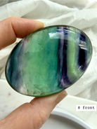 Teal fluorite palm stone #8 front view featuring bold blue green banding and polished oval shape