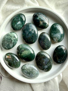 Moss agate palm stones with green dendritic inclusions, polished grounding crystals for calm, emotional balance, and meditation