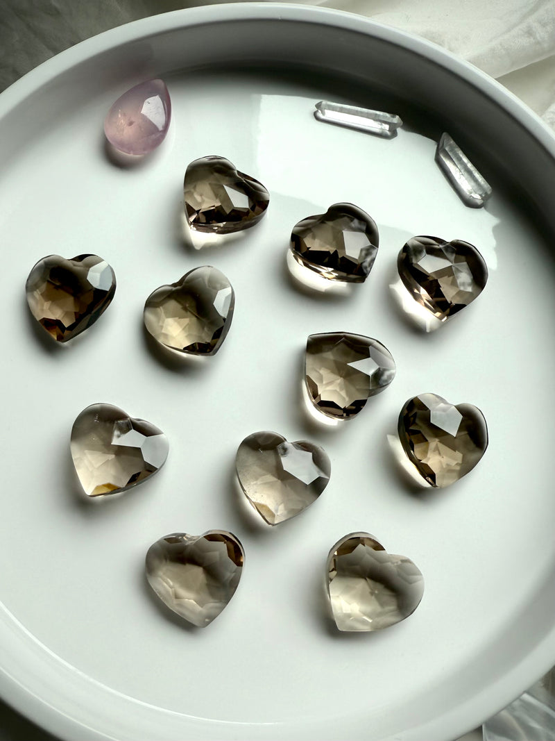 Gem Cut Smokey Quartz Hearts shown on a white plate, photographed in natural light