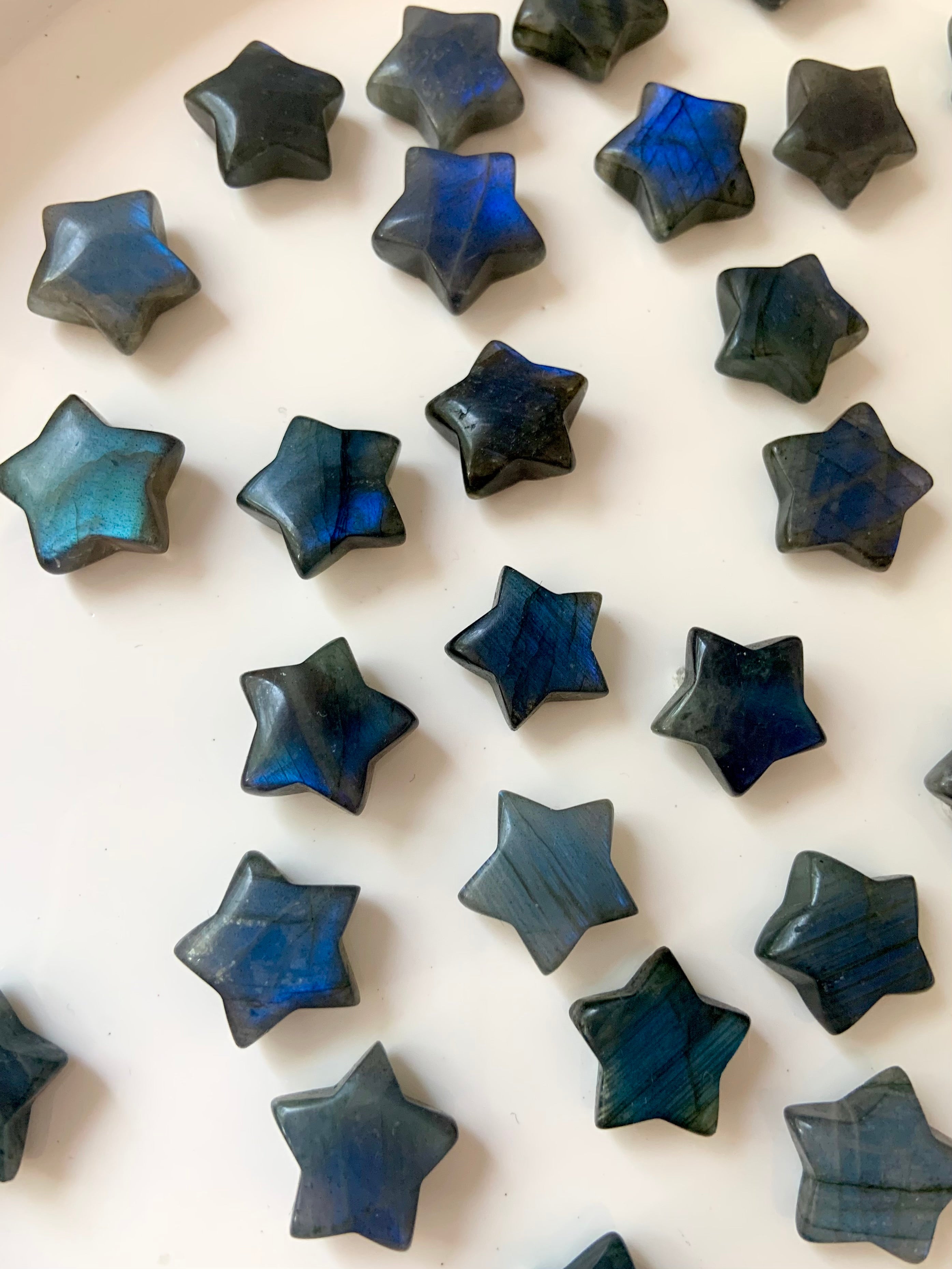 Labradorite mini crystal stars with deep blue flash, shown at an angle to highlight natural variations in color, shimmer &amp; stone texture.