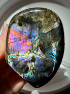 Polished Labradorite freeform with vibrant rainbow flash and natural dark matrix