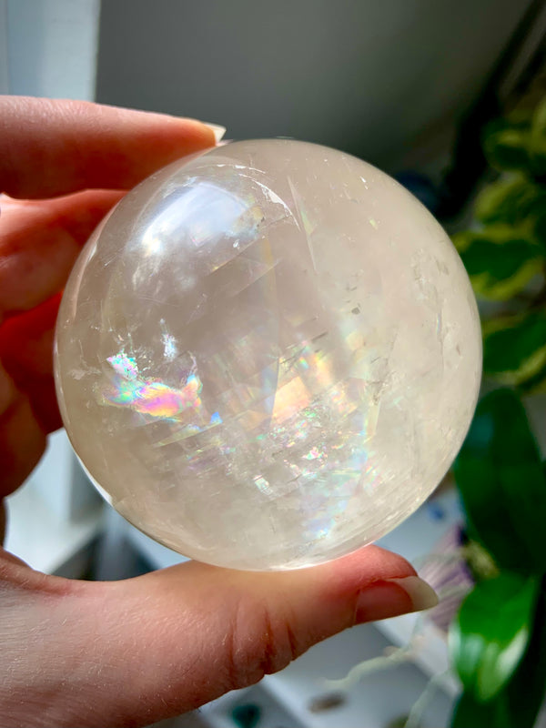 High quality Rainbow Honey Calcite Sphere comes with a wood stand