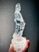 Side view of hand-carved Clear Quartz Quan Yin Goddess of Compassion statue with radiant transparency