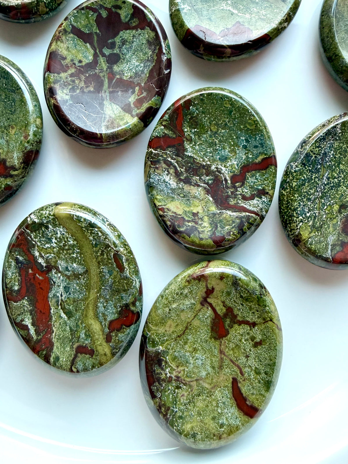 Polished Dragon Blood Stone thumb stones with distinctive green and red mineral formations for grounding and protection