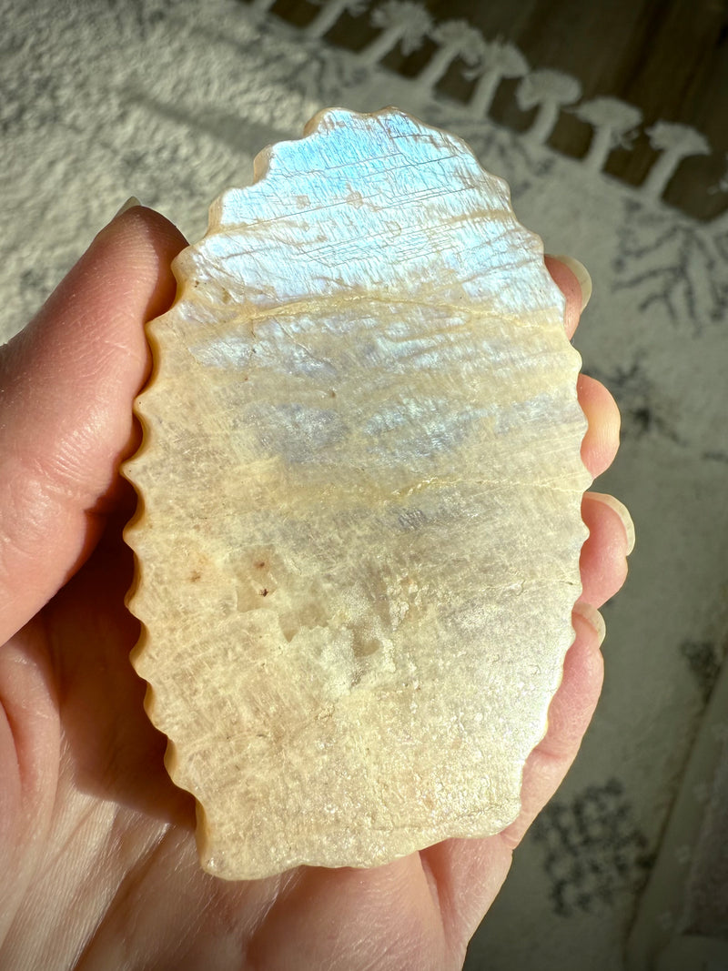 The back of the Mother Mary carving is smooth with lots of shimmer in the Moonstone