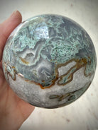 75mm Moss Agate sphere showing natural Quartz veins, earthy green patterns, and polished finish
