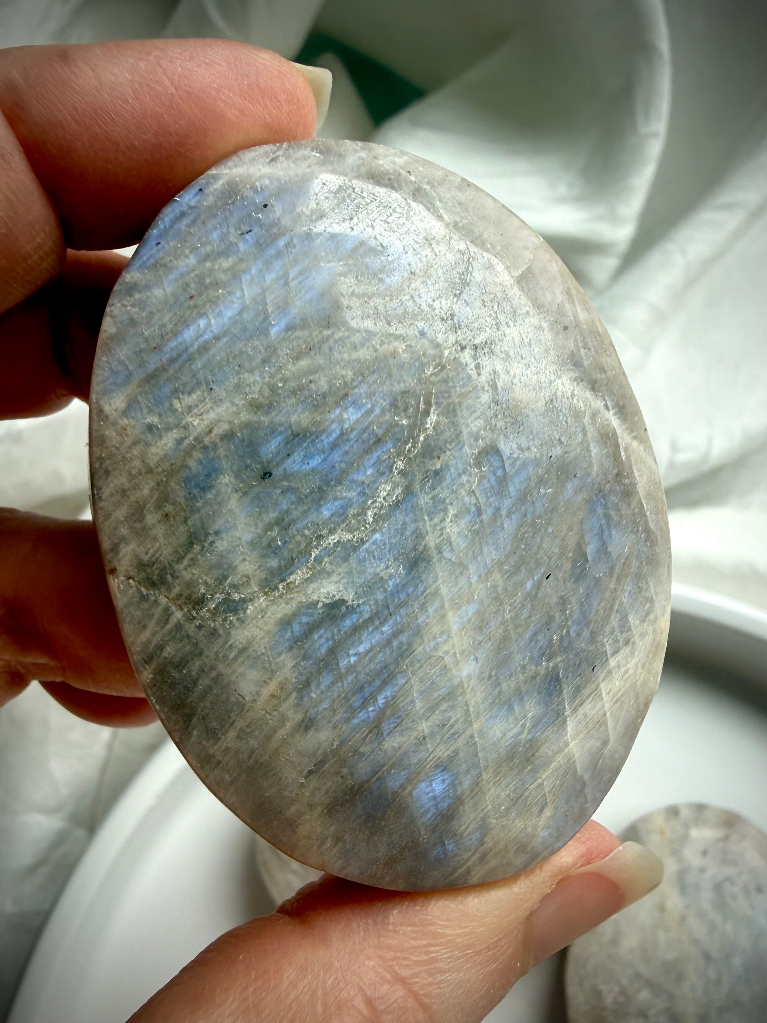 belomorite moonstone crystal palm stone with luminous blue flash and feldspar shimmer