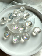 Collection of rainbow girasol mini quartz crystal spheres with luminous milky translucence and soft mystical glow