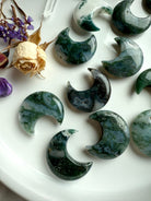 Close-up of Moss Agate crystal moons showing variation in color, translucence, and mossy inclusions.