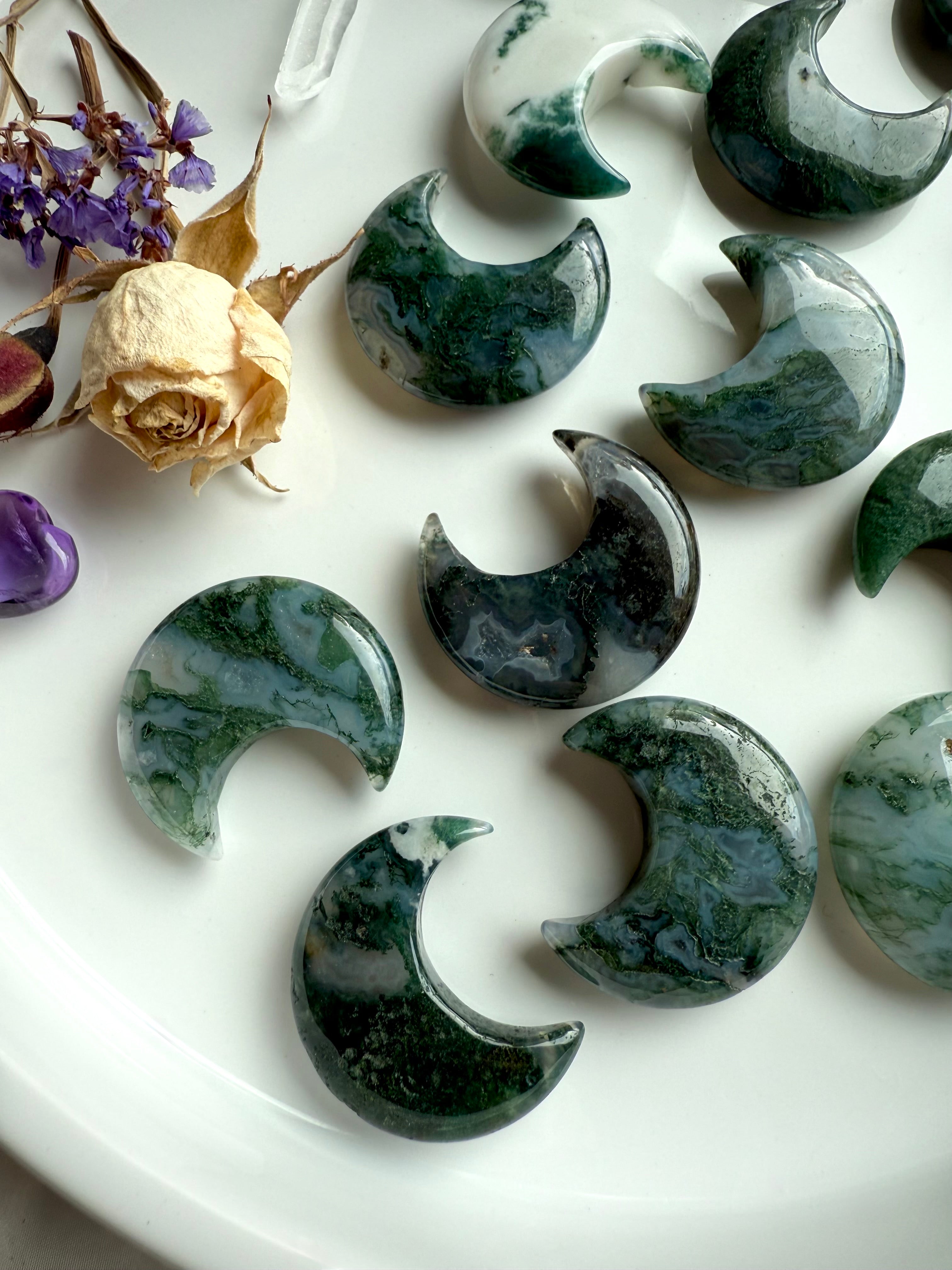 Close-up of Moss Agate crystal moons showing variation in color, translucence, and mossy inclusions.
