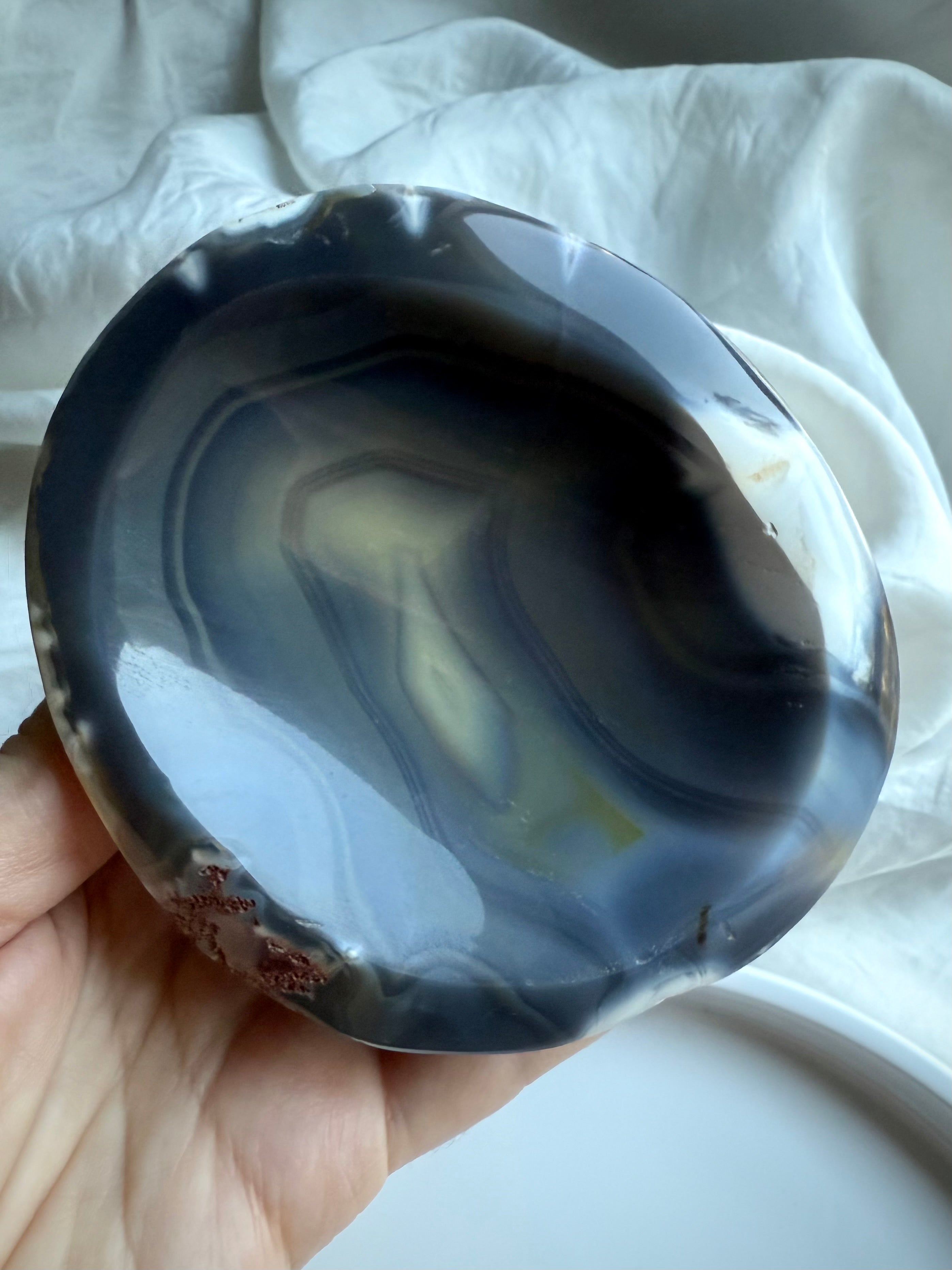 Orca Agate offering bowl with layered oceanic bands in charcoal, cream, and sand tones — grounding stone bowl for altar work and protective rituals.